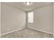 A cozy bedroom featuring neutral-colored walls, carpet, and a window providing natural light at 30276 Armenia Rd, Leesburg, FL 34748