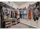 Walk-in closet featuring ample hanging space and shoe racks, ideal for storage at 30276 Armenia Rd, Leesburg, FL 34748
