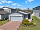 Charming home with a two-car garage, lovely landscaping, and a welcoming entrance at 30276 Armenia Rd, Leesburg, FL 34748