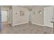 Spacious hallway with tile flooring, neutral walls, and white doors leading to various rooms at 30276 Armenia Rd, Leesburg, FL 34748