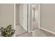 Hallway leading to a carpeted bedroom with an open door and natural light at 30276 Armenia Rd, Leesburg, FL 34748