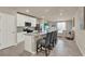 Modern kitchen with granite countertops, white cabinets, stainless steel appliances, and island with seating at 30276 Armenia Rd, Leesburg, FL 34748