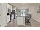 Modern kitchen with an island, stainless steel appliances, and open layout to the living area at 30276 Armenia Rd, Leesburg, FL 34748