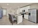 Modern kitchen features a large island, granite countertops, stainless steel appliances and white cabinets at 30276 Armenia Rd, Leesburg, FL 34748