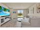 Cozy living room with tile floors, a comfy sectional, and a sliding glass door opening to the backyard at 30276 Armenia Rd, Leesburg, FL 34748