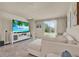 Inviting living room with tile floors, a comfortable sectional sofa, and a sliding glass door to the backyard at 30276 Armenia Rd, Leesburg, FL 34748
