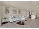 Open-concept living room with neutral tones, tile floors, and modern decor at 30276 Armenia Rd, Leesburg, FL 34748