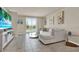Bright living room featuring tile flooring, neutral paint, and a comfortable sectional sofa at 30276 Armenia Rd, Leesburg, FL 34748