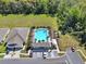 Aerial view of a community pool area with lounge chairs and lush landscaping at 30276 Armenia Rd, Leesburg, FL 34748