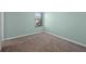 Well-lit bedroom with soft green walls and a window providing natural light and views at 335 Merry Brook Cir, Sanford, FL 32771