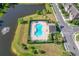 Aerial view of the community pool next to a lake and community at 335 Merry Brook Cir, Sanford, FL 32771