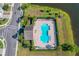 Aerial view of the community pool with lounge chairs and palm trees at 335 Merry Brook Cir, Sanford, FL 32771