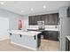 Modern kitchen with stainless steel appliances, white quartz countertop island, and dark cabinets at 335 Merry Brook Cir, Sanford, FL 32771