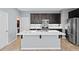 Bright kitchen island with stainless steel faucet, undermount sink and modern white countertops at 335 Merry Brook Cir, Sanford, FL 32771