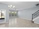 Spacious living room with tile flooring and natural light, complemented by staircase access at 335 Merry Brook Cir, Sanford, FL 32771