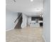 Open-concept living area with staircase, flowing into the kitchen and dining space at 335 Merry Brook Cir, Sanford, FL 32771