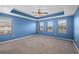 Spacious main bedroom with tray ceiling, plush carpeting, and abundant natural light from multiple windows at 335 Merry Brook Cir, Sanford, FL 32771