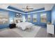 Serene main bedroom with tray ceiling, plush carpeting, and abundant natural light from multiple windows at 335 Merry Brook Cir, Sanford, FL 32771