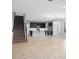 Open floorplan with a kitchen island, stainless appliances, and staircase access at 335 Merry Brook Cir, Sanford, FL 32771