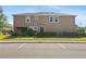 Rear exterior of a two-story home featuring a neutral color palette and well-maintained landscaping at 335 Merry Brook Cir, Sanford, FL 32771
