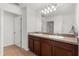 Bathroom featuring double sinks with cabinets and large mirror at 340 Irving Bend Dr, Groveland, FL 34736