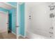 Well-lit bathroom featuring a tub with white tile surround and open doorway at 340 Irving Bend Dr, Groveland, FL 34736