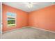 Bedroom with a window providing natural light and neutral carpeting at 340 Irving Bend Dr, Groveland, FL 34736