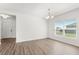 Dining room featuring a chandelier, sleek flooring, and a bright window at 340 Irving Bend Dr, Groveland, FL 34736