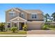 Charming two-story home with a brick driveway and well-maintained landscaping showcasing curb appeal at 340 Irving Bend Dr, Groveland, FL 34736