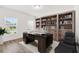 A well-appointed home office with custom built-in bookshelves, a large desk, and ample natural light at 340 Irving Bend Dr, Groveland, FL 34736