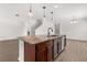 Kitchen island with granite countertop, sink, and pendant lighting, part of an open-concept area at 340 Irving Bend Dr, Groveland, FL 34736