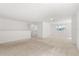 Spacious loft area with neutral carpet, windows, and open layout at 340 Irving Bend Dr, Groveland, FL 34736