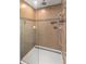 Tiled shower with rainfall showerhead and glass door at 340 Irving Bend Dr, Groveland, FL 34736