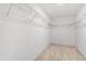 Spacious walk-in closet featuring wire shelving and neutral carpet at 340 Irving Bend Dr, Groveland, FL 34736