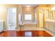 Bright and airy bathroom featuring a soaking tub, separate shower, and dual vanities for convenience at 3509 Battersea Ct, Belle Isle, FL 32812