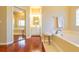 Bright bathroom with wood flooring, white cabinets, and a bathtub with a fluffy stool at 3509 Battersea Ct, Belle Isle, FL 32812