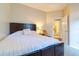 Serene bedroom with a comfortable bed, neutral colors, and access to an en-suite bathroom at 3509 Battersea Ct, Belle Isle, FL 32812