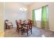 Formal dining area featuring a chandelier, a large window, and stylish decor at 3509 Battersea Ct, Belle Isle, FL 32812