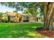 Inviting single-story home with a manicured lawn, mature trees, and well-maintained landscaping at 3509 Battersea Ct, Belle Isle, FL 32812