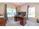 Bright home office with large windows, a spacious desk setup, and neutral tones for a productive workspace at 3509 Battersea Ct, Belle Isle, FL 32812