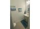 Clean powder room featuring pedestal sink and coastal artwork at 3623 Main Harbor Dr, Kissimmee, FL 34746