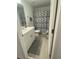 Functional bathroom with white cabinets, a modern shower curtain, and neutral gray accents for a clean and stylish look at 3623 Main Harbor Dr, Kissimmee, FL 34746