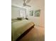 Inviting bedroom featuring a comfortable bed with green bedding, complemented by light walls and a ceiling fan at 3623 Main Harbor Dr, Kissimmee, FL 34746