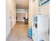 Bright hallway featuring tile flooring, white storage furniture, and an open view to the kitchen and living area at 3623 Main Harbor Dr, Kissimmee, FL 34746
