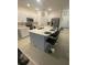 Modern kitchen featuring an island with bar seating, white cabinetry, and stainless steel appliances at 3623 Main Harbor Dr, Kissimmee, FL 34746