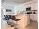 Bright kitchen featuring an island with bar seating, white cabinetry, and stainless steel appliances at 3623 Main Harbor Dr, Kissimmee, FL 34746