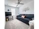 Comfortable living room featuring a gray sofa, neutral carpet, and a bright window, ideal for relaxing and entertaining at 3623 Main Harbor Dr, Kissimmee, FL 34746