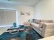 Bright living room with a sectional sofa, a stylish rug, and large windows providing ample natural light at 3623 Main Harbor Dr, Kissimmee, FL 34746