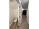 A full bathroom featuring a toilet and wood-look flooring, situated off a hallway at 366 Madison Dr, Davenport, FL 33837