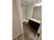 Bathroom with wood-look flooring, white tub and shower, white toilet and vanity with dark cabinets at 366 Madison Dr, Davenport, FL 33837